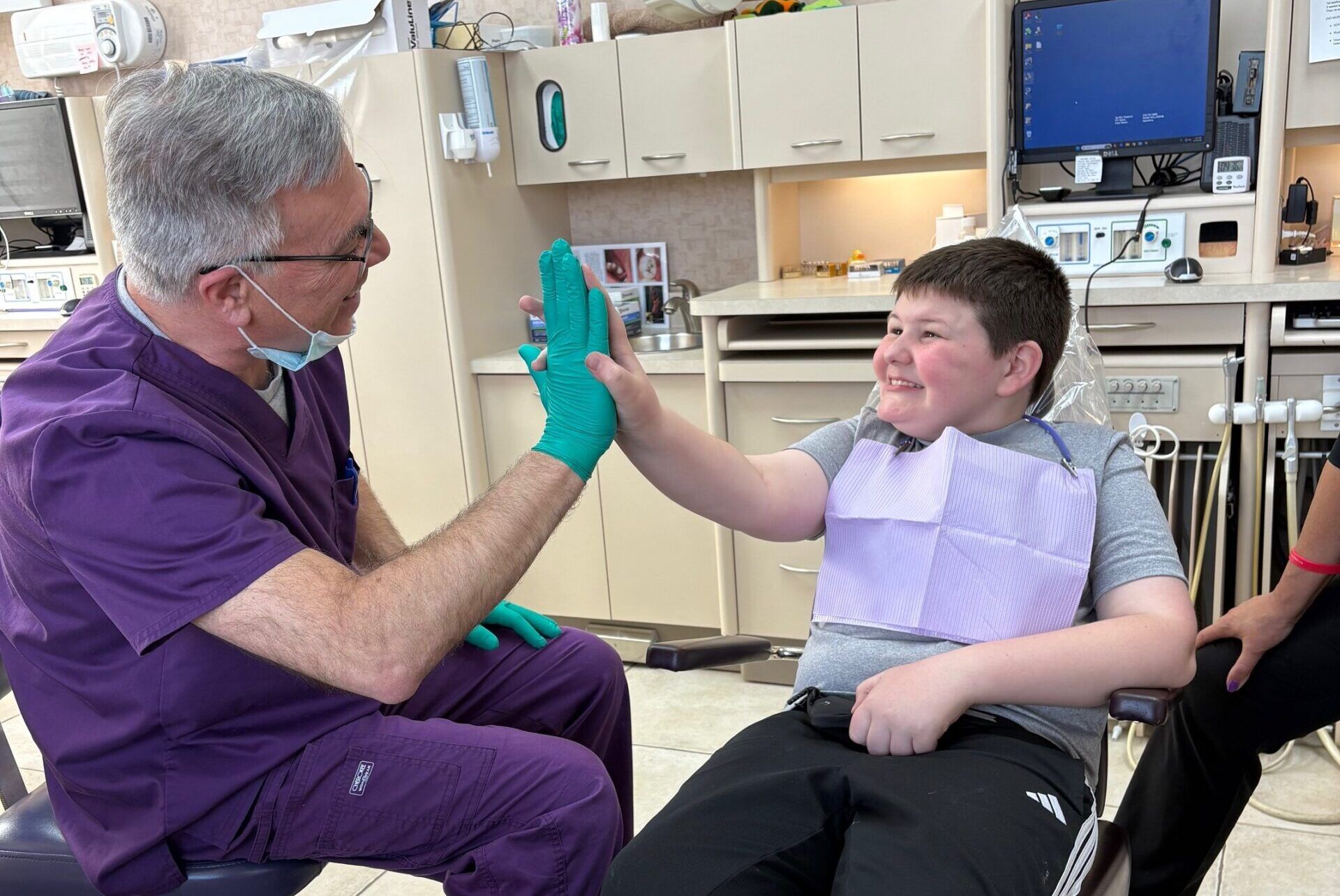 dentist and special needs patient high fiving